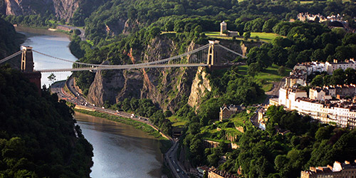 The Avon river and surrounding Avon Gorge. The iconic Clifton Suspension Bridge crosses them, with Clifton Observatory visible behind it.