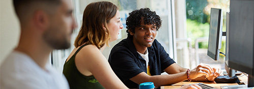 Students looking at computer