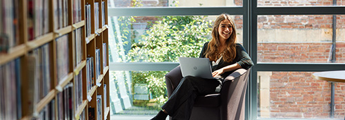 Student sat with laptop